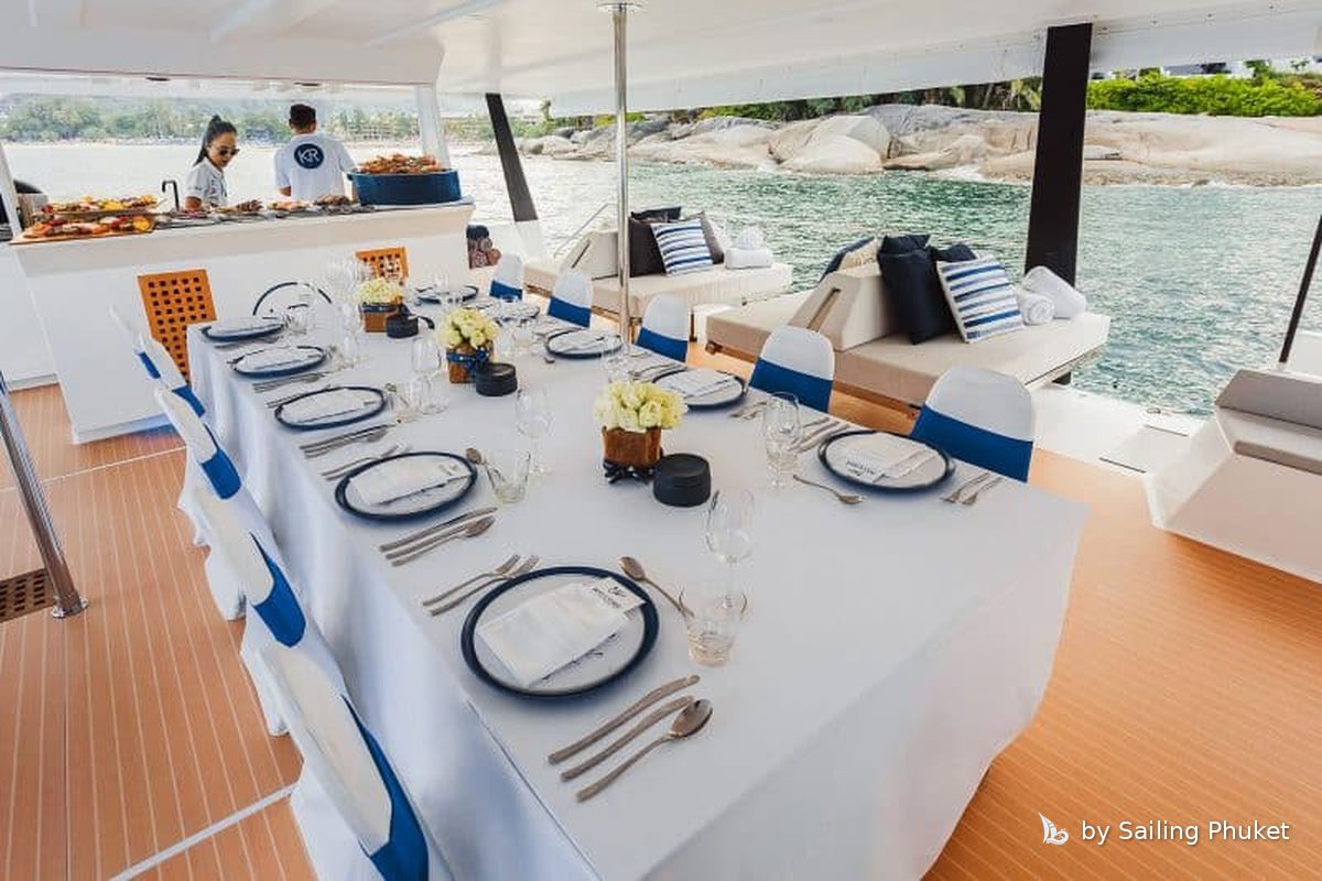 Long dining table on a private catamaran in Phuket