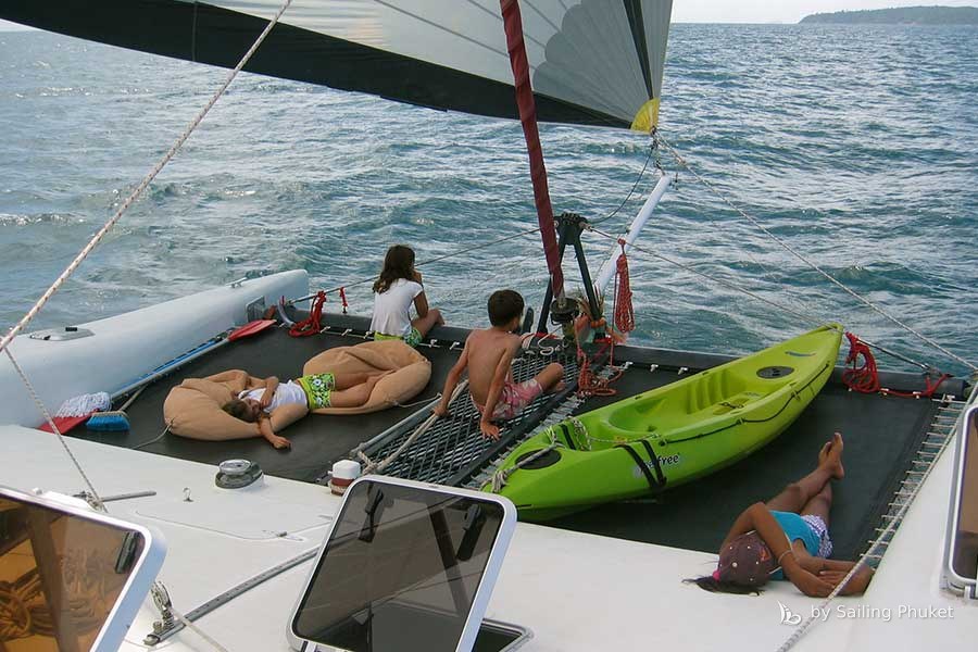Relaxing on deck with kayaks on Full Steam